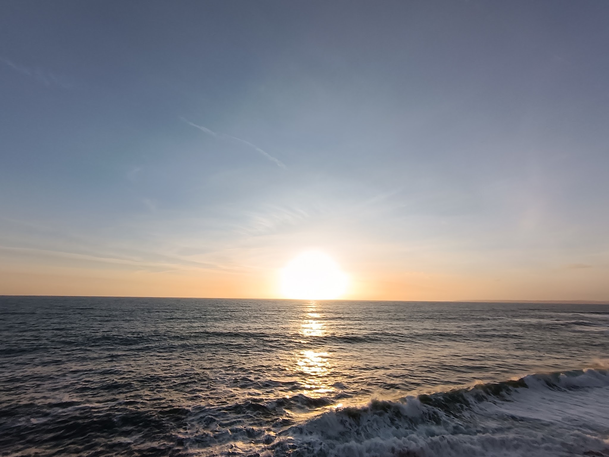 The sun setting over the sea