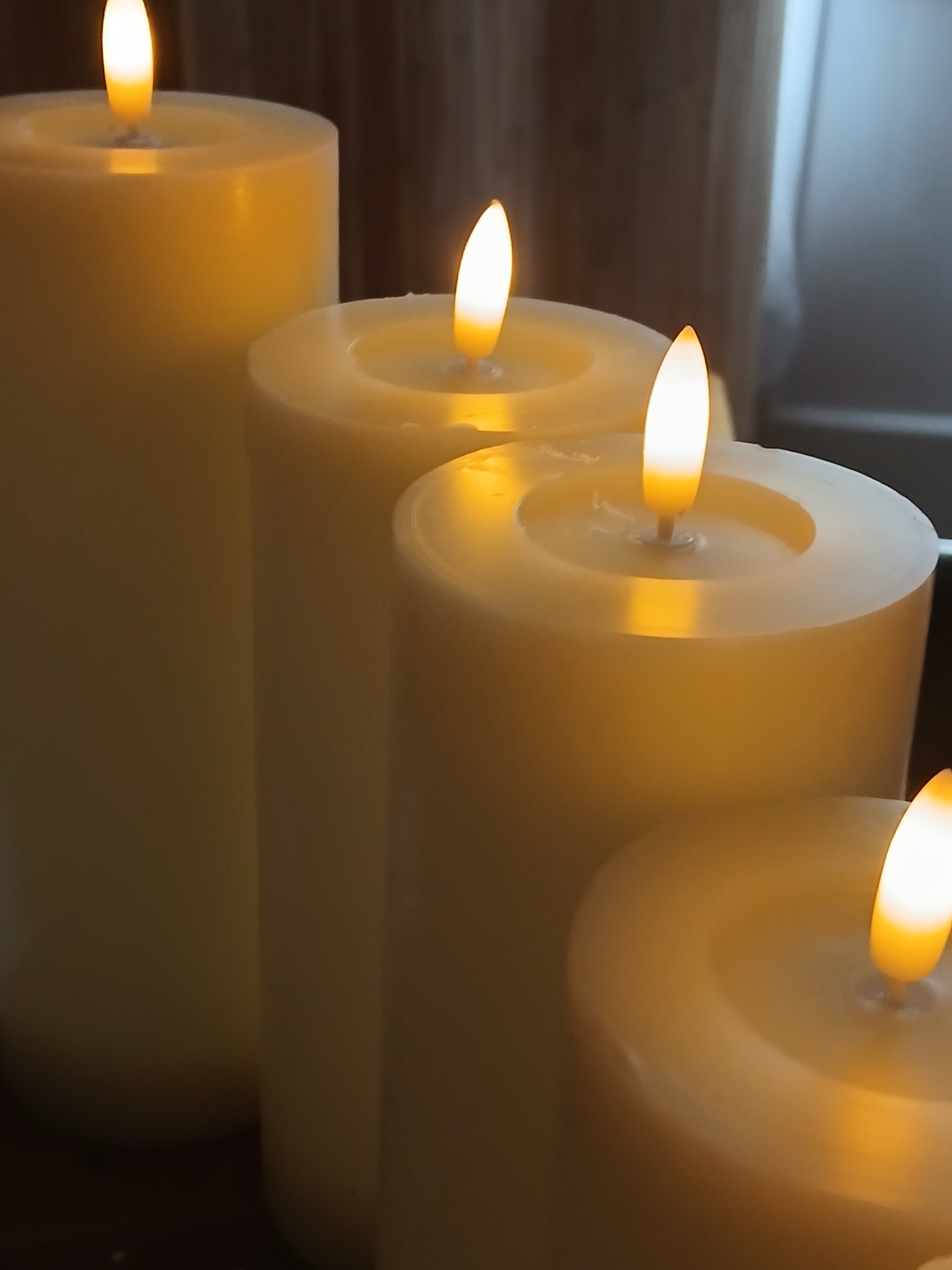 Lit pillar candles glowing in the treatment room