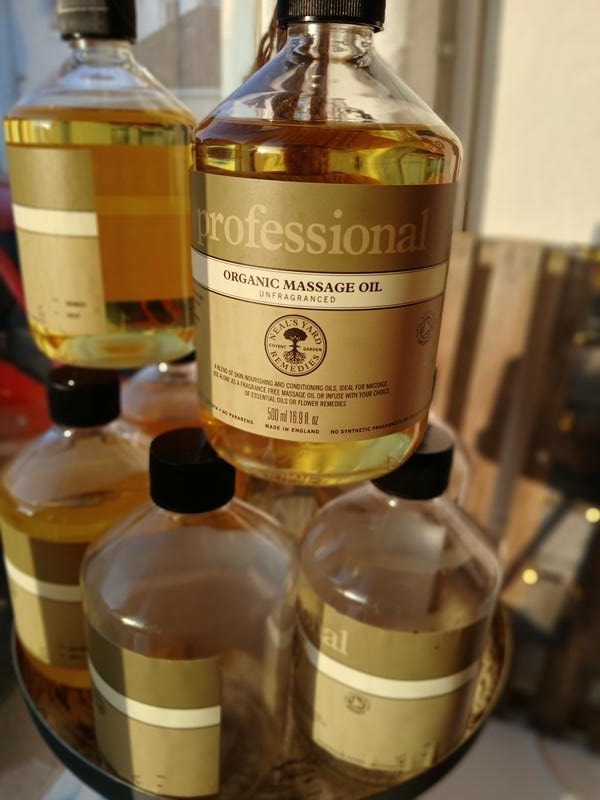 Bottles of Neal's Yard Remedies professional organic massage oil