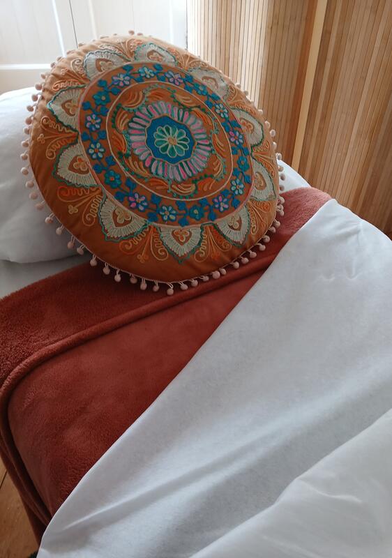 An embroidered mandala cushion on the couch